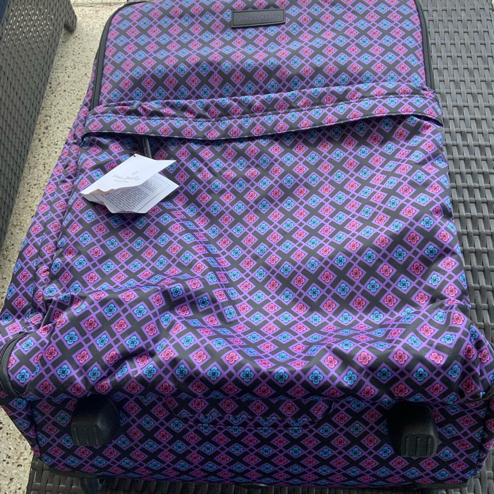Brand new Vera Bradley Lighten up 26 inch roller bag with storage bag.